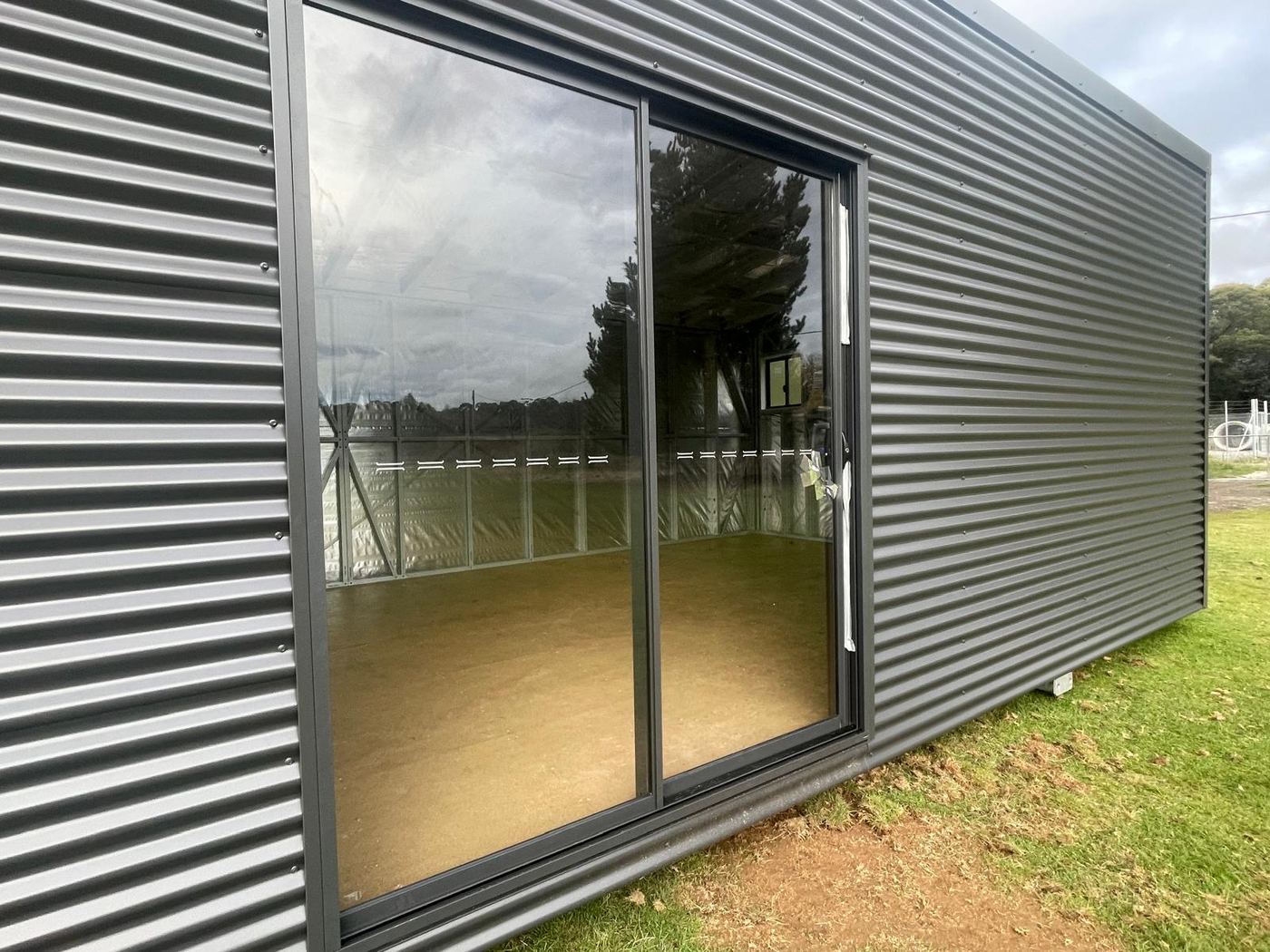 Charcoal corrugated shell · double sliding glass
